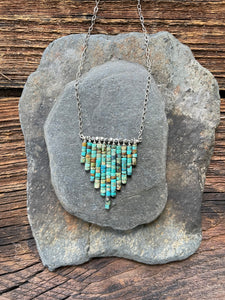 Raw hand cut turquoise waterfall necklace. Turquoise beads with silver accents.